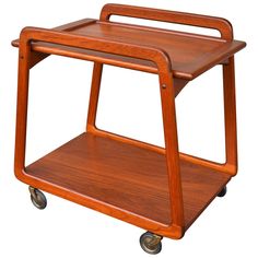 a wooden serving cart with wheels on white background