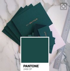 pantone's color swatches on top of a marble table with rulers