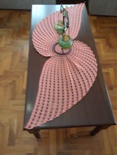 a coffee table with an umbrella design on it's top and two vases