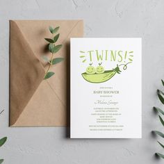 a baby shower is displayed next to an envelope with the word twins on it and green leaves