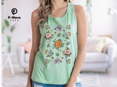 This is the perfect flowy tank top to add a touch of floral charm to your wardrobe. The delicate floral pattern is a beautiful and elegant design that is perfect for any occasion. Made from high-quality materials, this tank top is soft, comfortable, and stylish. This women's flowy racerback tank is the go-to tank for sporty types. It boasts a flowy look that flatters the silhouette. Looks great and feels better. Overlocking side seams hold the shape of the strong polyester material. A self-fabric binding with overlock is both decorative and protective.  * 65% Polyester 35% Viscose * Extra Light fabric  * Relaxed fit * Sewn in label * Runs smaller than usual Key Features: * Floral print * Comfortable fit * Stylish design * Perfect for summer * Great for everyday wear Sizing: * XS:       Wid Green Floral Print Tank Top, Green Floral Print Tank Top For Summer, Bohemian Floral Print Sleeveless Blouse Tank Top, Bohemian Floral Print Sleeveless Tank Top, Bohemian Tank Top With Floral Print, Bohemian Floral Print Tank Top, Green Floral Print Tank Top For Spring, Green Floral Print Sleeveless Tank Top, Green Floral Print Cotton Tank Top