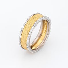 two tone gold and silver wedding rings with beaded edges, set against a white background