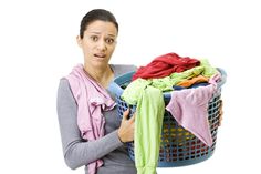 a woman holding a laundry basket full of clothes