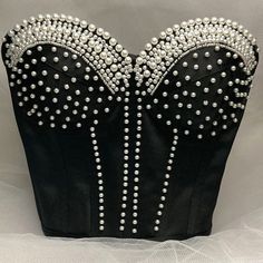 Featuring intricate rhinestones and beadwork, this stunning corset top is perfect for any special occasion. The back is designed with adjustable lace-up ties, ensuring a perfect fit every time. Each piece is custom-made with love and crafted to perfection. Order yours today and shine bright! Elegant Strapless Embellished Corset, Glamorous Embellished Fitted Corset, Glamorous Fitted Embellished Corset, Glamorous Rhinestone Corset For Night Out, Embellished Elegant Corset For Night Out, Glamorous Embellished Party Corset, Elegant Embellished Corset For Night Out, Elegant Embellished Sleeveless Corset, Glamorous Fitted Corset With Rhinestones