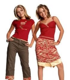 two young women standing next to each other wearing red tops and brown pants with gold trims