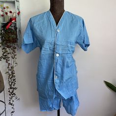 Great vintage 1960s blue cotton summer pajamas set. Brand is John Wells LTD.  Tagged size B but please see measurements for best fit.  Best size guess is a men's XS/small or women's medium depending on desired fit.   Elastic waist band. Great vintage condition with no flowers found.  Measurements taken flat. Double where applicable.  Shirt  pit to pit 19 inches  length 27 inches  shorts  waist 13 to about 17 inches stretched Rise 14 inches  hips 20 1/2 inches  inseam 5 inches Light Blue Cotton Pajama Party Set, Light Blue Cotton Sleepwear For Home, Light Blue Cotton Sleepwear, Light Blue Summer Sleepwear For Home, Blue Cotton Short Sleeve Sleepwear, Light Blue Short Sleeve Summer Sleepwear, Blue Short Sleeve Sets For Home, Vintage Cotton Sets For Daywear, Retro Fitted Sleepwear For Loungewear