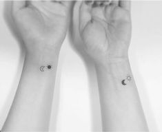 two wrist tattoos with the moon and stars on each one hand, both in black and white