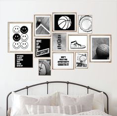 a white bed topped with lots of pictures and posters on the wall next to a metal headboard