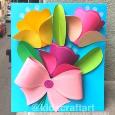 a colorful card with paper flowers on it