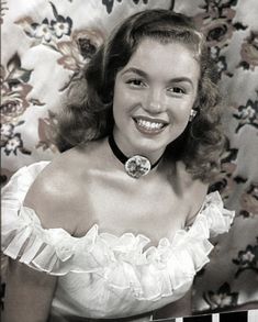 a black and white photo of a woman smiling