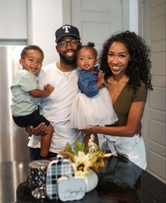 a man, woman and two children posing for a photo