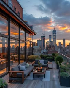 an outdoor living area with couches, tables and plants on the roof of a building