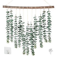 a wind chime with green leaves hanging from it