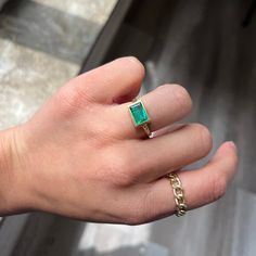 This antique-inspired emerald bezel ring is a bold beauty, bringing tons of color and charm to your ring collection. The chunky gold bezel hugs that Colombian emerald and emphasizes her geometric edges - the darkened engraved shoulders give a Renaissance vibe which we're also quite fond of. The stone sits in the East/West orientation, allowing for maximum spread across the top of the finger. 18kt yellow gold Size 6.25 & resizable Measures: 9.05 x 6.08 x 2.86mm GIA Report Here Please see qualitat Rectangular Emerald Jewelry With Bezel Setting, Rectangular Gold Emerald Ring With Bezel Setting, Emerald Ring With Bezel Setting And Open Design, Emerald Open Ring With Bezel Setting, Green Rectangular Bezel Set Ring, Green Rectangular Rings With Bezel Setting, Emerald Bezel Ring, Modern Mens Rings, Jewel Necklace