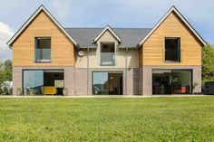 a large house sitting on top of a lush green field