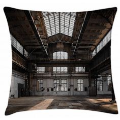 an empty warehouse with high ceilings and windows