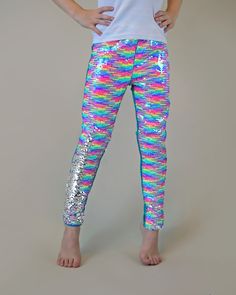 "Transform any occasion into a celebration with our dazzling sequined pants at Whitney Elizabeth! Crafted for ultimate comfort with a breathable cotton side, these pants flip the fun with a colorful, sequined reverse side. The perfect blend of style and comfort, ensuring your little one shines at every party with flippin' fun! * Front: 100% polyester | Back: 100% cotton * Hand wash for lasting sparkle and hang dry for endless flippin' fun! * If your little one is between sizes, we recommend sizi Jojo Siwa Shirts, Sequined Pants, Mermaid Pants, Dress Up Leggings, Magic Pants, Rainbow Pants, Unique Pants, Rainbow Leggings, Belle Costume