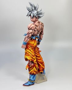 a statue of gohan is shown on a white background with an orange and blue flame