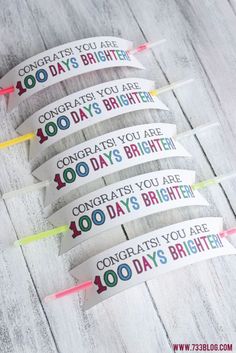 four birthday candles with the words congrats you are 100 days brighter on them