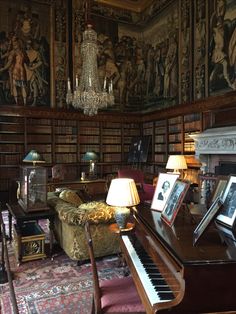 a living room filled with furniture and a piano