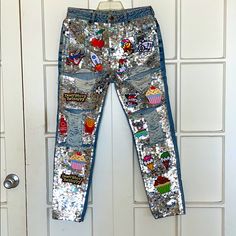 a pair of sequinized jeans hanging on a door