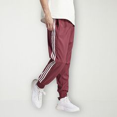 Whether you're exercising at home or at the gym, this adidas men's mid-rise workout pant is a wardrobe essential. It's made from a woven recycled fabric and features an adjustable drawstring waist, regular-fit, multiple pockets, and cuffed leg detail. Front Style: Flat FrontFeatures: Adjustable WaistClosure Type: Drawstring, Full ElasticFit: Regular FitPockets: 1 Cargo Side Pocket, 2 Side Slip PocketsRise: Mid RiseFiber Content: 100% Recycled PolyesterFabric Description: WovenInseam: 31 InLeg St Exercising At Home, Rise Workout, Adidas Mens, At The Gym, Recycled Fabric, Side Pocket, Workout Pants, Adidas Men, Drawstring Waist