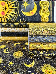 the sun, moon and stars are printed on black fabric with gold foiling in different colors