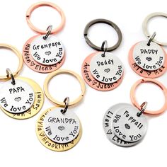 six different types of key chains with names and words on them, including one that says grandpa