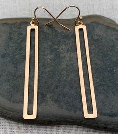 "Simple and stunning long gold earrings. They are timeless and versatile. Lightweight and perfect for everyday wear. Dress them up or down. The earrings measure 2\" long 1/4\" wide. They hang from simple gold ear wire hooks. Overall drop length is 2 1/8\". Made from plated gold. I have this same earring style also available in silver. Here is a direct link https://www.etsy.com/listing/1239786346/ Thanks for stopping by! Please take a moment and visit the rest of my Etsy shop. I have many more un Rose Gold Minimalist Linear Pierced Earrings, Gold Rectangular Linear Earrings For Everyday, Minimalist Long Drop Rose Gold Earrings, Gold Minimalist Pierced Linear Earrings, Gold Minimalist Linear Pierced Earrings, Gold Minimalist Linear Earrings, Matte Gold Minimalist Earrings For Everyday, Minimalist Rose Gold Brass Earrings, Minimalist Brass Linear Earrings With Long Drop