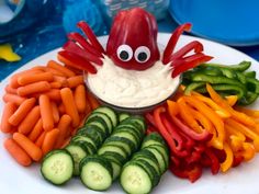 a white plate topped with carrots and cucumbers