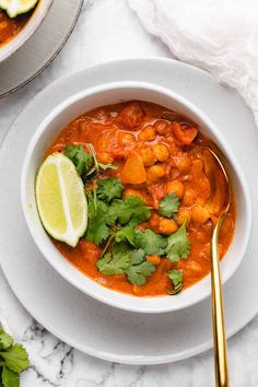 a white bowl filled with soup and garnished with cilantro