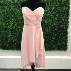 a dress on a mannequin in front of a green wall