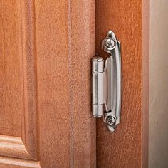 a close up of a door handle on a wooden door