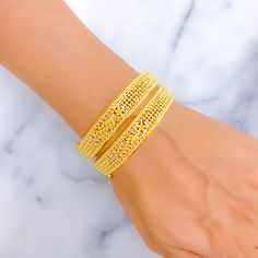 This pair of bangles is masterfully crafted from 22k gold, totaling 35.5 grams, and polished to a high shine in yellow gold. The bangles are each sized at 2.5 inches with a practical opening diameter of 2.3 inches, ensuring a snug fit for easy wear. The design features a subtle, flowy leaf pattern that adds a natural and graceful touch to the classic gold bangle. Each bangle is openable, equipped with a screw and hinge mechanism for secure closure and convenience. Ideal for those who appreciate the beauty of nature-inspired jewelry, these bangles offer a refined aesthetic that complements both formal attire and casual looks, perfect for everyday elegance or special occasions. PRODUCT DETAILS Gold Purity(karat): 22k Gold Weight(grams): 35.5 Item Finish: Yellow Gold Bangle Size: 2.5 Bangle O Yellow Gold-plated Bangle Bracelet, Hand Set 22k Gold Bangle, Yellow 22k Gold Bracelet For Festive Occasions, Yellow 22k Gold Festive Bracelet, Festive 22k Gold Yellow Bracelets, Festive Yellow 22k Gold Bracelet, Gold-plated Yellow Bangle With Intricate Design, Yellow Gold Plated Bangle With Intricate Design, 22k Gold Bangles