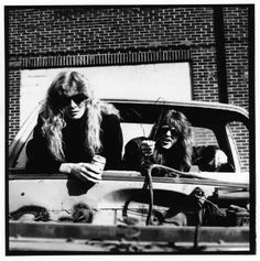 two women sitting in the back of a pick up truck