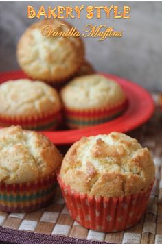 three muffins sitting on top of a red plate next to another cupcake