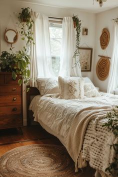 a bedroom with white linens and plants on the window sill in front of the bed