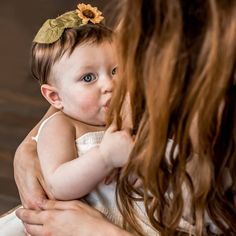 a woman holding a baby in her arms