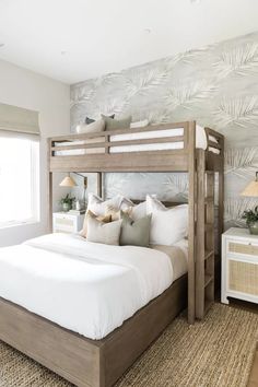 a bedroom with a bed, nightstands and two lamps on either side of the bed