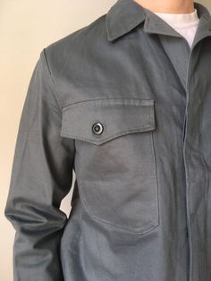 Deadstock Size - S Vintage German Workwear Jacket  Chore Coat Sanfor MoleskinThis vintage worker`s  jacket is in wonderful  deadstock condition- name brand - Leber- made in Germany- color – grey- 2 outside pockets - 2 button on the cuffs- 4 buttons at front- material - cotton- label size - 46 (watch measurements)FLAT Measurements:Shoulders : 6 (15cm)Chest (underarm to underarm) : 21 inches (53cm)Sleeve : 24 inches (61cm)Length(back) : 25 inches (64cm)Pay your attention to that  most antique item Military Style Cotton Outerwear For Work, Utility Jacket With Flap Pockets For Workwear, Utility Jacket With Patch Pockets For Workwear, Utility Jacket With Multiple Pockets For Workwear, Military Cotton Outerwear For Work, Fitted Utility Jacket With Patch Pockets, Long Sleeve Utility Jacket With Side Pockets For Work, Workwear Utility Jacket With Lapel Collar And Multiple Pockets, Utility Jacket With Welt Pockets For Work