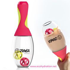 a person is holding an electric toothbrush in front of a bottle with the word zumba on it