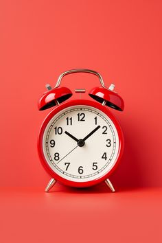 an alarm clock on a red background