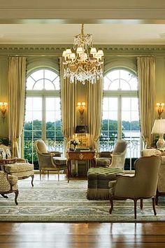 a living room filled with furniture and a chandelier