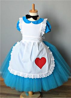 a blue and white dress with a red heart on it