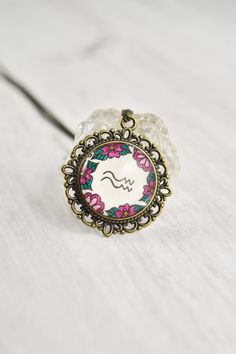 Your zodiac necklace collection is not complete without a floral Aquarius necklace. Handmade with whimsical pen art and a vintage style, this Aquarius pendant ignites your inner magic. The Aquarius jewelry is painted by hand, making each piece unique and one of a kind, just like you. Click through to see more hand painted jewelry!