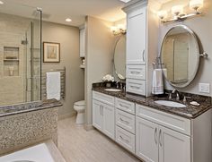 a large bathroom with two sinks and mirrors