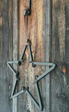 a metal star hanging on the side of a wooden wall