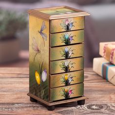 This beautifully crafted wooden jewelry box designed by Peruvian artisan Asunta Pelaez showcases a delightful mix of nature's beauty. Featuring vibrant tulip and dragonfly motifs, each panel is brought to life using the traditional reverse painted glass technique. With its charming design and practical compartments, it's the perfect way to keep your jewelry neatly stored and easy to find. Unique Hand Painted Butterfly Jewelry, Painted Jewelry Boxes Boho, Artistic Hand-painted Multicolor Jewelry, Bohemian Dragonfly Jewelry For Gifts, Painted Jewlrey Boxes, Jewelry Box Design, Reverse Painted Glass, Glass Jewelry Box, Brown Jewelry