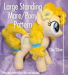 the large stuffed pony is yellow and has flowers on it's head, as well as