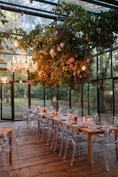 an outdoor dining area with chandelier and tables set up for a formal function